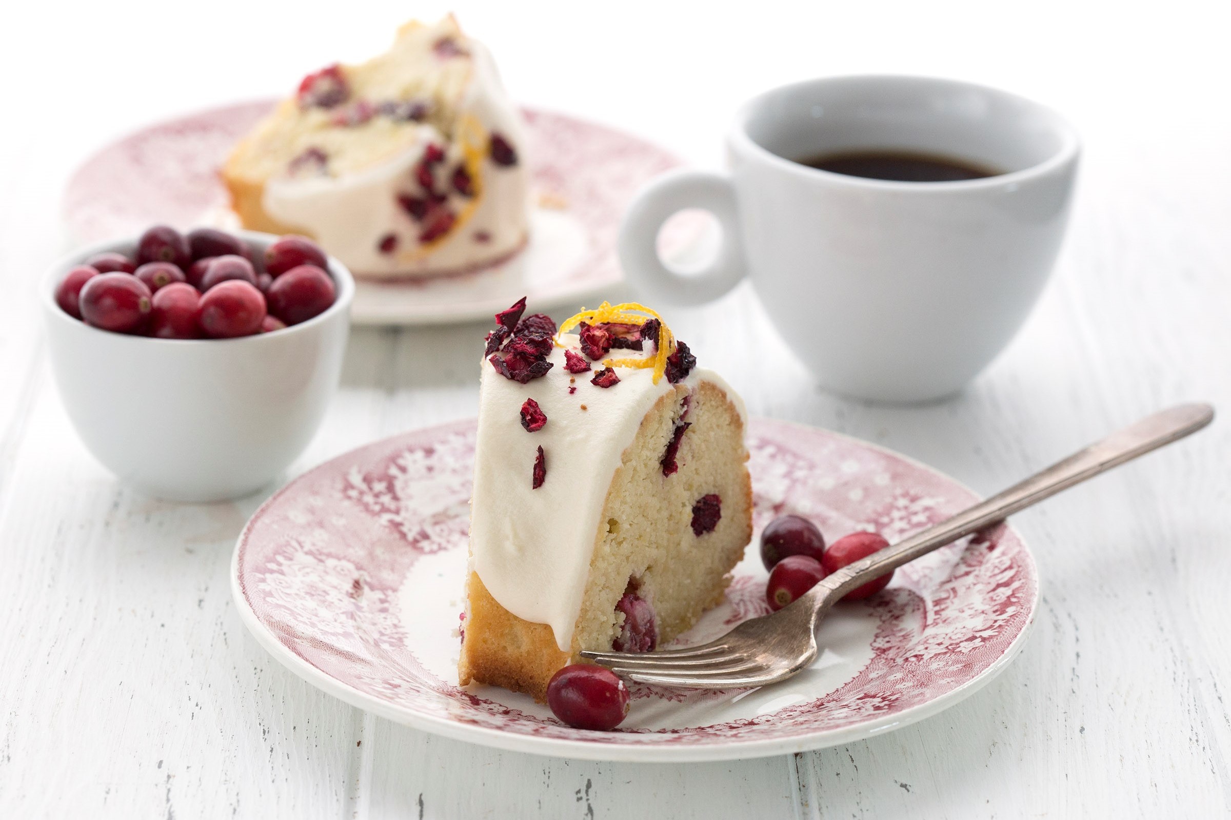 This beautiful, gluten-free, keto, cranberry bliss pound cake is perfect for the holidays. It features a moist interior with hints of cranberry and orange zest. The cake is topped with a cream cheese glaze. And served with hot coffee. | peteandgerrys.com