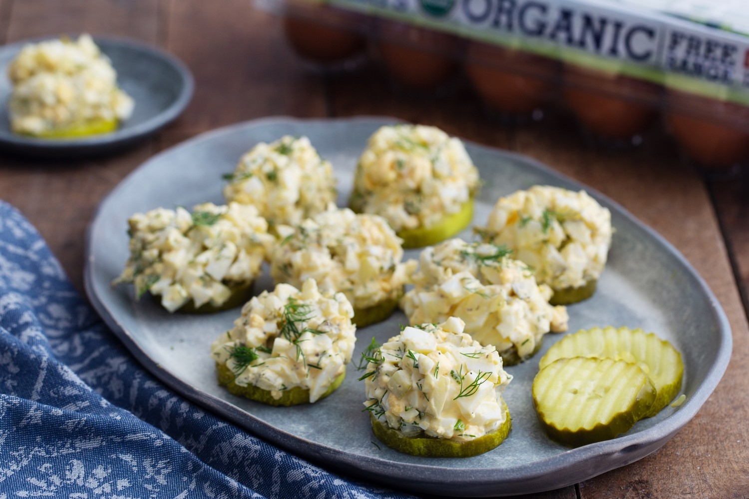 Keto dill pickle egg salad served on pickle slices and topped with fresh dill for a healthy, zesty, low carb snack. | peteandgerrys.com 