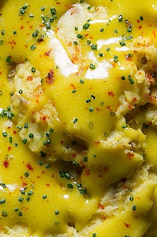 Thee delicious yukon-gold potatoes are mashed with olive oil, chives, and fresh bay leaves. The potatoes are topped with a golden aïoli made with organic eggs. | peteandgerrys.com 