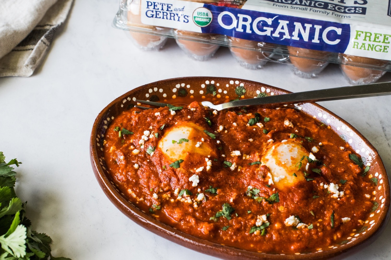 Huevos ahogados (or "drowned eggs"). Pete and Gerry's Organic Eggs gently poached in a smooth, smoky red salsa made from toasted guajillo chiles, chile de arbol, Roma tomatoes, and Mexican oregano.