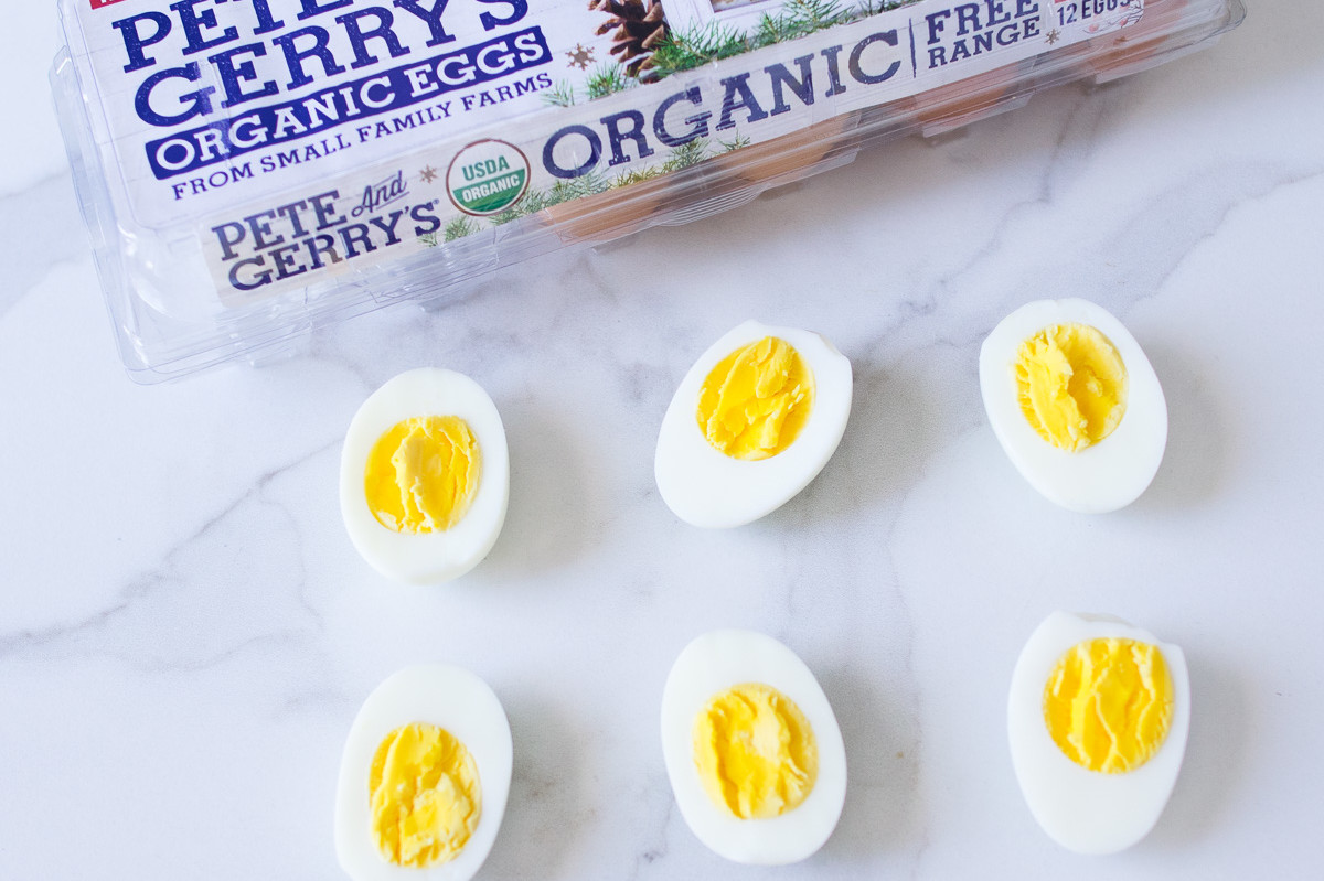 These instant pot hard-boiled eggs are a quick and easy alternative to the traditional method. Pictured is halved organic eggs with bright yolks. | peteandgerrys.com 