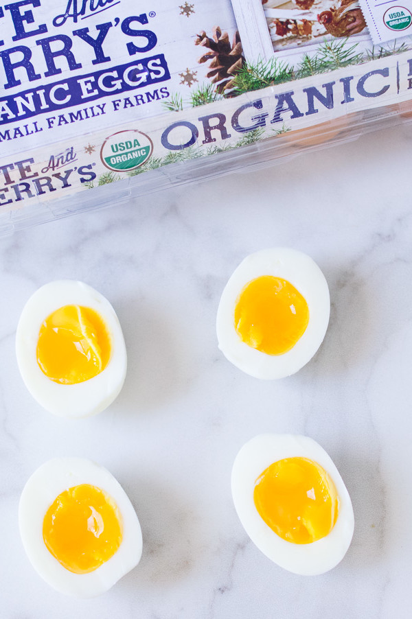 This instant pot recipe features perfect soft boiled eggs. Pictured is halved soft boiled eggs with gold luscious yolk interiors. | peteandgerrys.com 