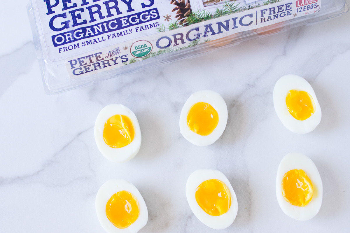 This instant pot recipe features perfect soft boiled eggs. Pictured is halved soft boiled eggs with gold luscious yolk interiors. | peteandgerrys.com 