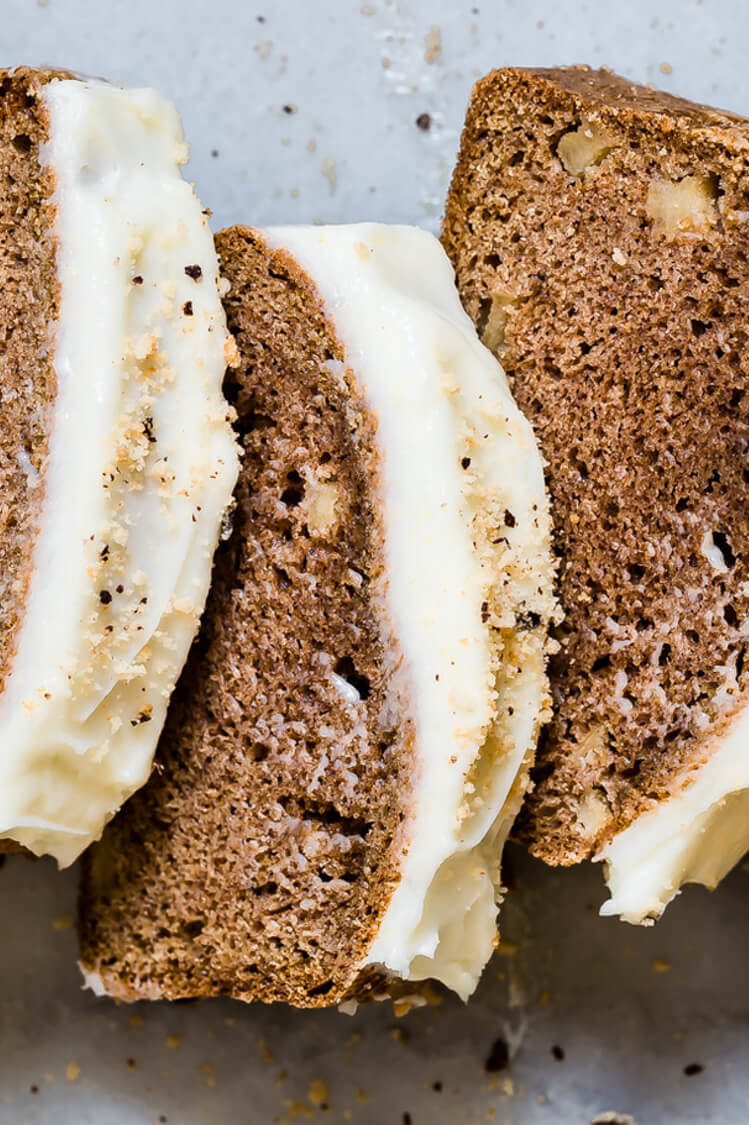 This spiced apple loaf features pieces of real apple, ground cinnamon, nutmeg, and cloves. The loaf is topped with an easy frosting made with confectionary sugar and cream cheese. | peteandgerrys.com 