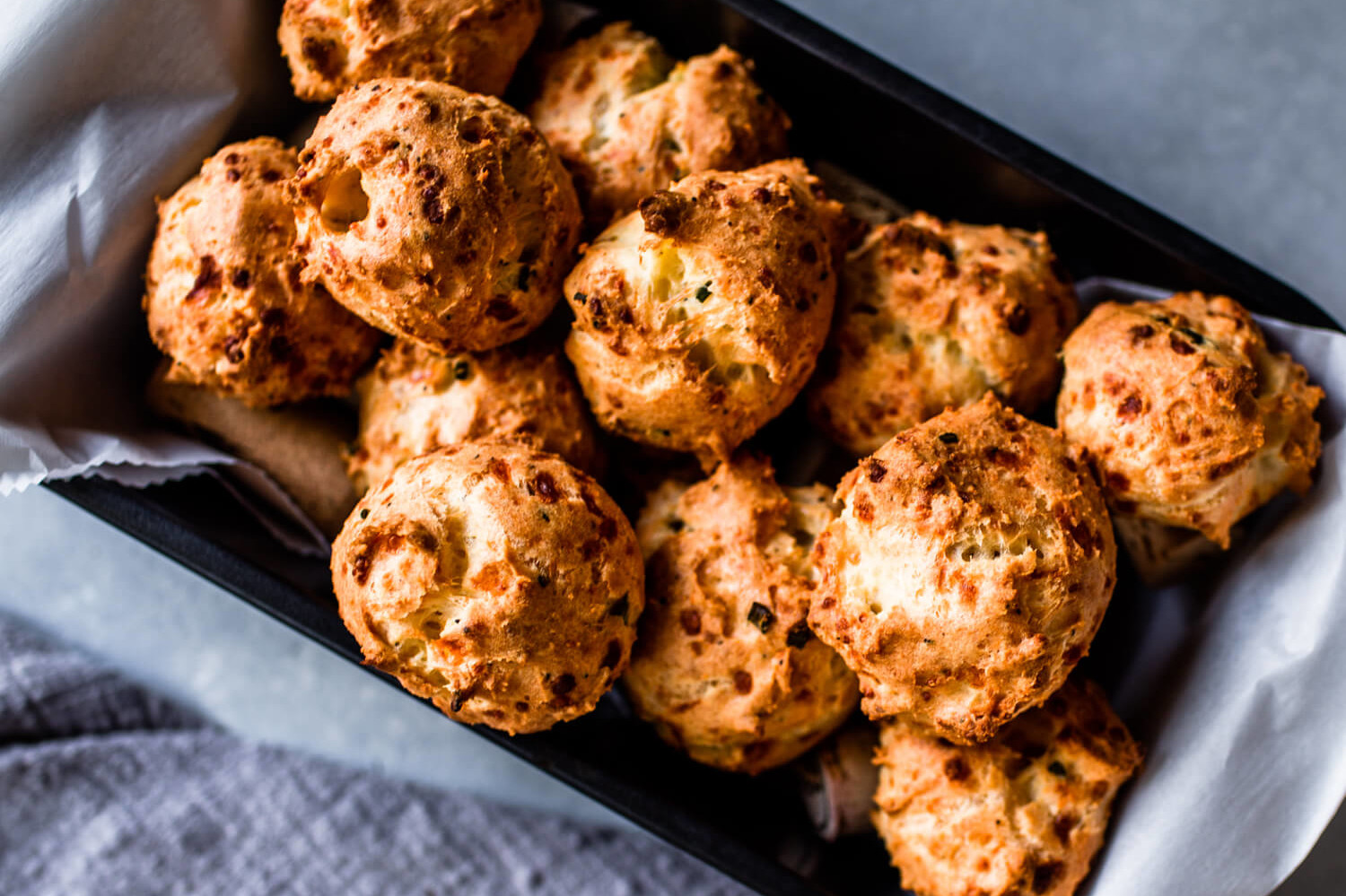 Crispy, golden brown, round Asiago gougères made from choux pastry and filled with cheese and chives. A quick and easy appetizer or finger food for any party. | peteandgerrys.com 