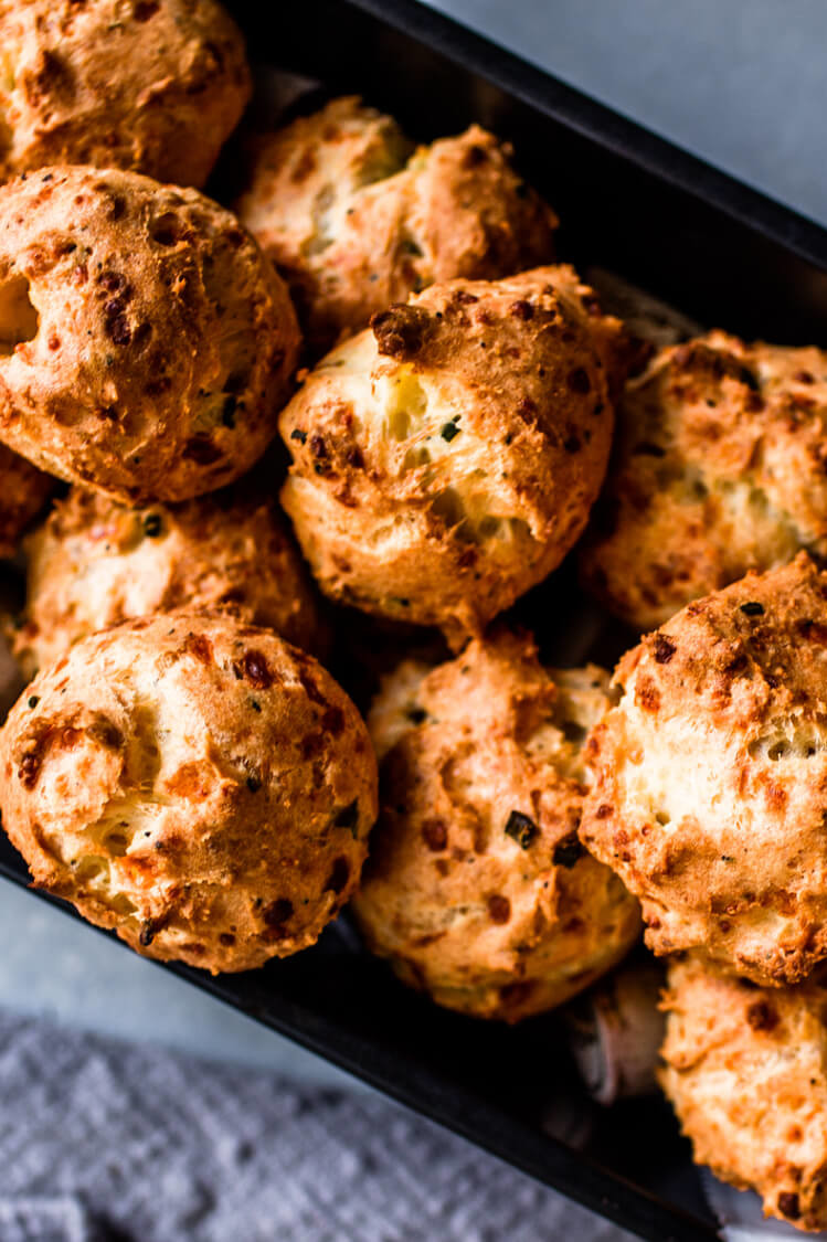 Crispy, golden brown, round Asiago gougères made from choux pastry and filled with cheese and chives. A quick and easy appetizer or finger food for any party. | peteandgerrys.com 