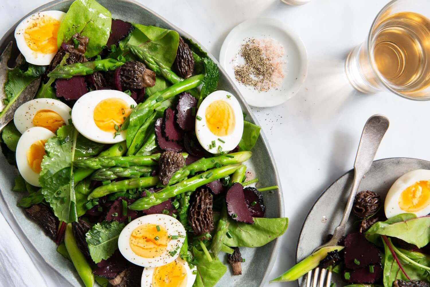 Heart-healthy and nutritious salad featuring crisp asparagus, morel mushrooms, shaved black truffle, and halved hard-boiled eggs. Served with a black mushroom and truffle oil vinaigrette. | peteandgerrys.com 