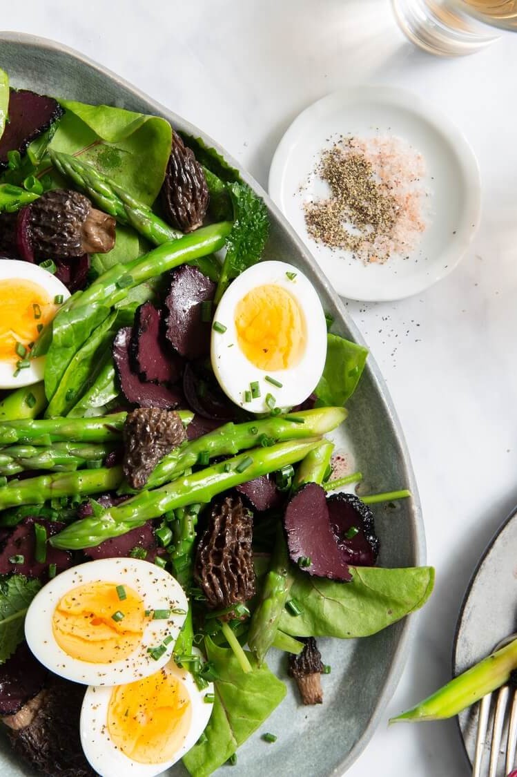 Heart-healthy and nutritious salad featuring crisp asparagus, morel mushrooms, shaved black truffle, and halved hard-boiled eggs. Served with a black mushroom and truffle oil vinaigrette. | peteandgerrys.com 