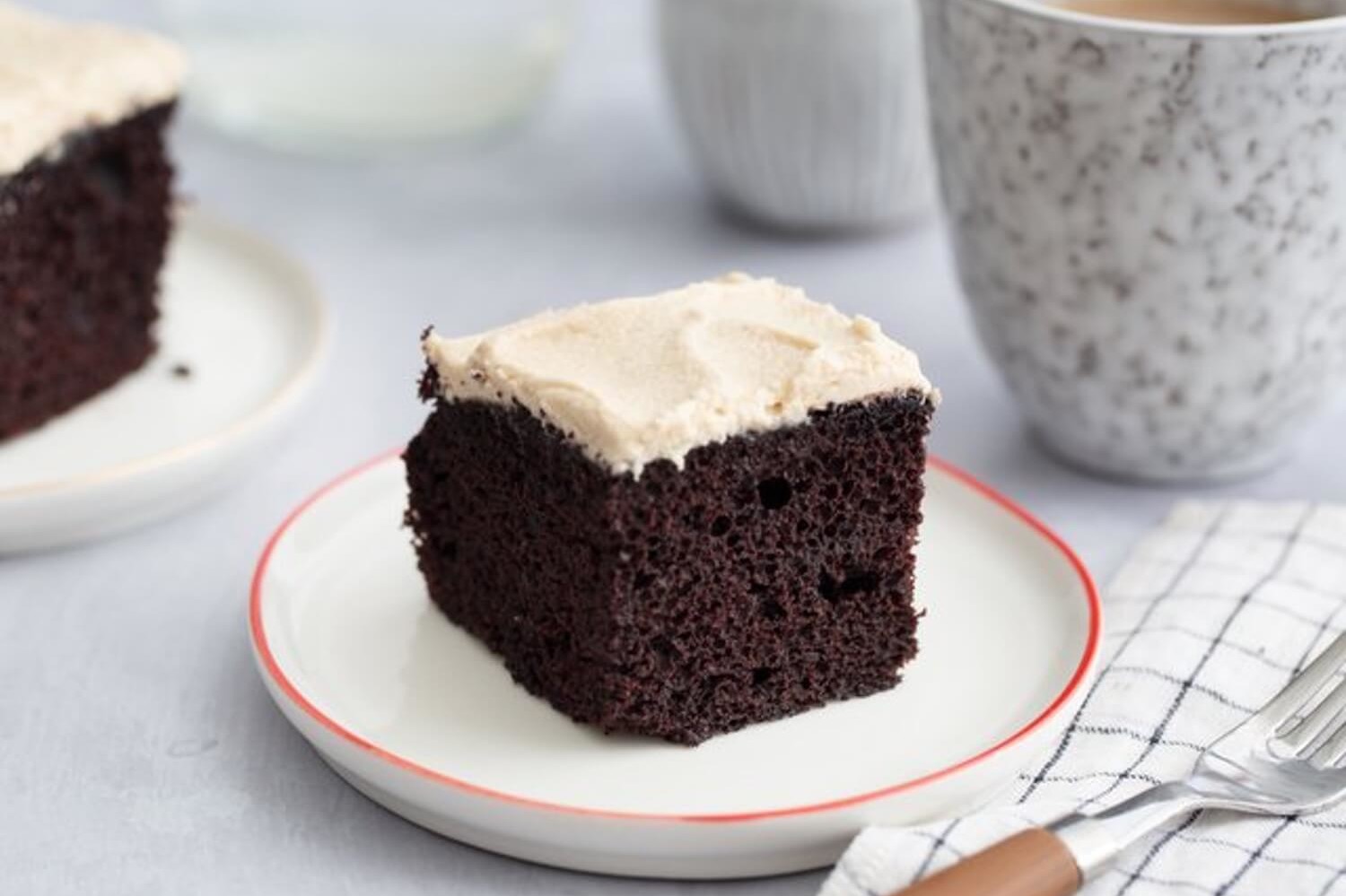 Rich chocolate sheet cake made with dutch cocoa and organic eggs, creating a moist interior shown in the cross section. Cake slice is frosted with a nutty peanut butter buttercream. | peteandgerrys.com 