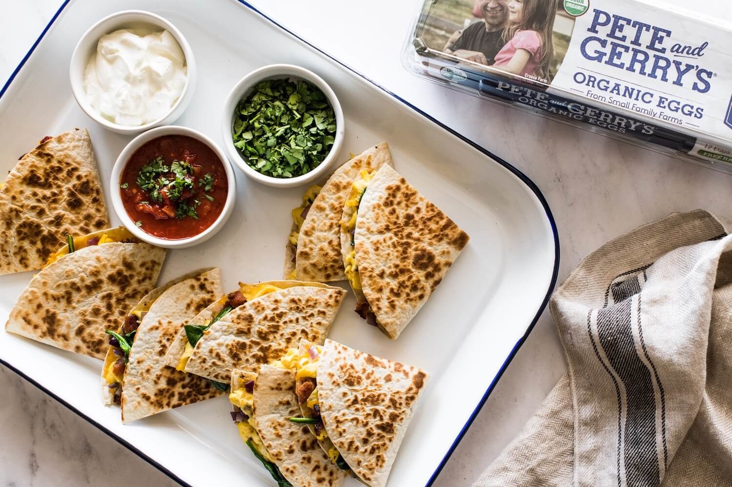 This quick and easy breakfast is kid-friendly and perfect on-the-go. Flour tortillas are cooked until golden brown and filled with scrambled organic eggs, bacon, spinach, and mozzarella cheese. | peteandgerrys.com 