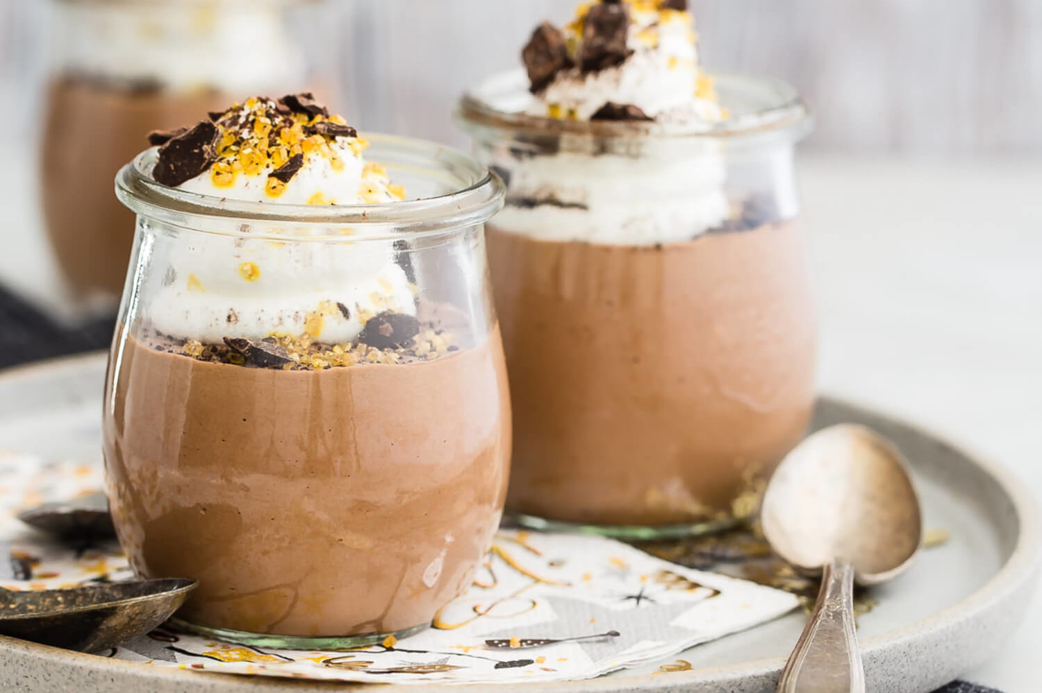 Recipe for classic chocolate mousse with a light, airy texture and a touch of brandy. Served in individual cups with with whipped cream, chocolate shavings, and gold sprinkles. | peteandgerrys.com 