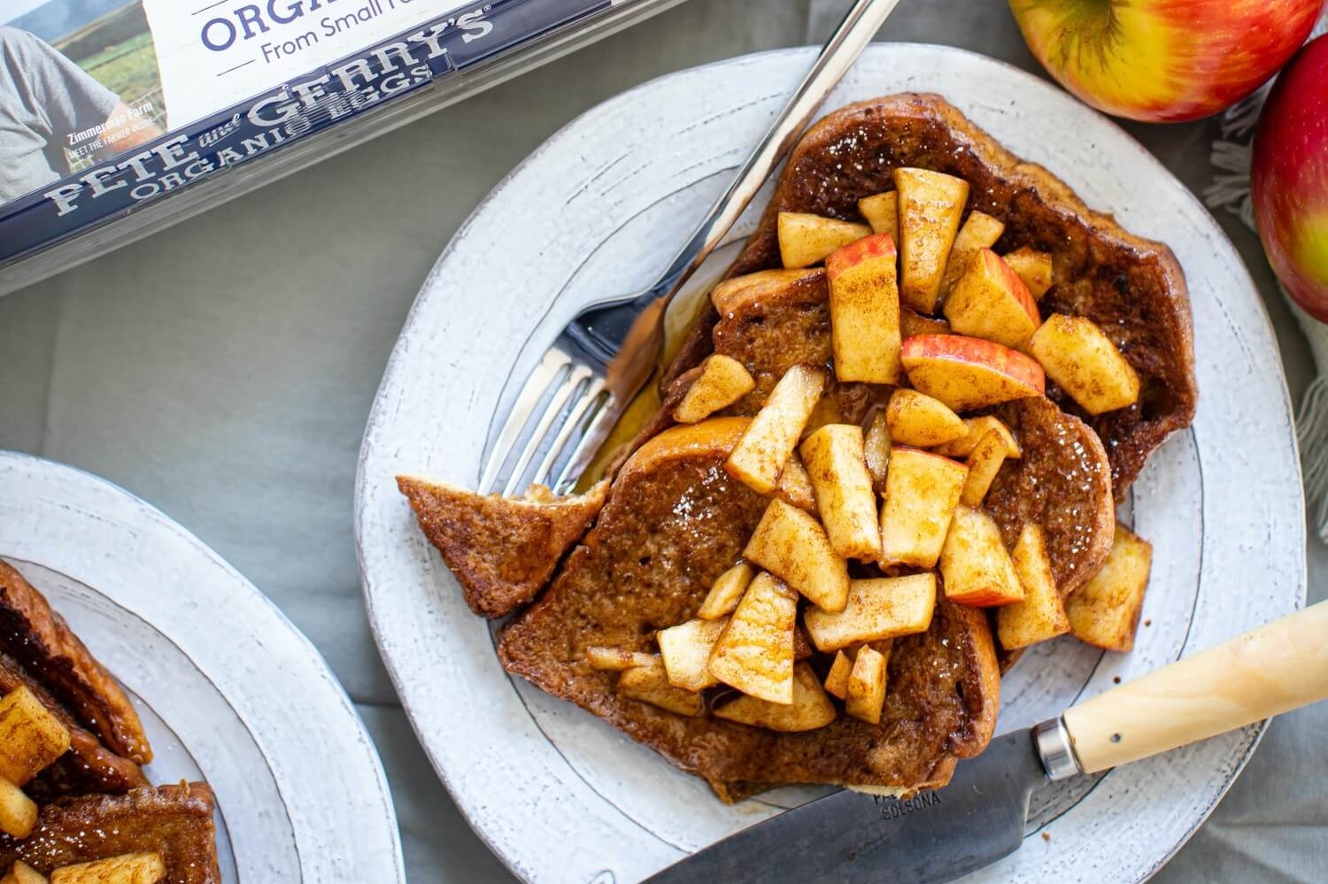 This cinnamon apple French toast is drenched in a custardy combination of egg, sugar, and cinnamon, then pan fried until golden brown and finished with chopped apple and maple syrup. | peteandgerrys.com