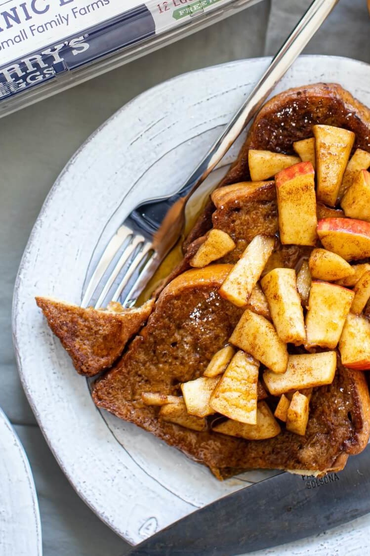 This cinnamon apple French toast is drenched in a custardy combination of egg, sugar, and cinnamon, then pan fried until golden brown and finished with chopped apple and maple syrup. | peteandgerrys.com