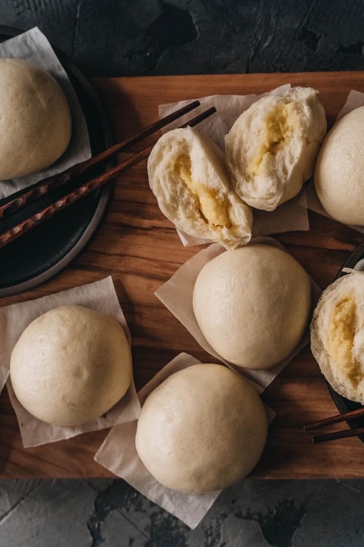 Pictured are fluffy and shiny, custard-filled buns. This recipe is made by Omnivore's Dilemma. Serve as dessert or alongside dinner. | peteandgerrys.com 