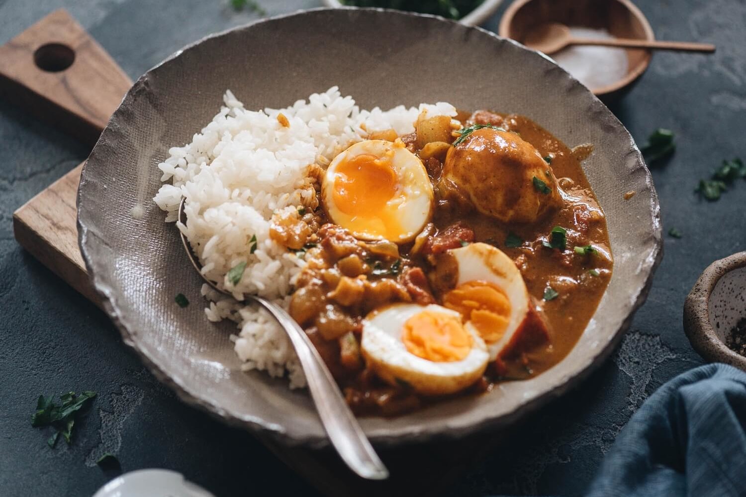 This easy egg curry features soft boiled organic eggs bathed in a buttery curry sauce, and served over hot white rice. | peteandgerrys.com 