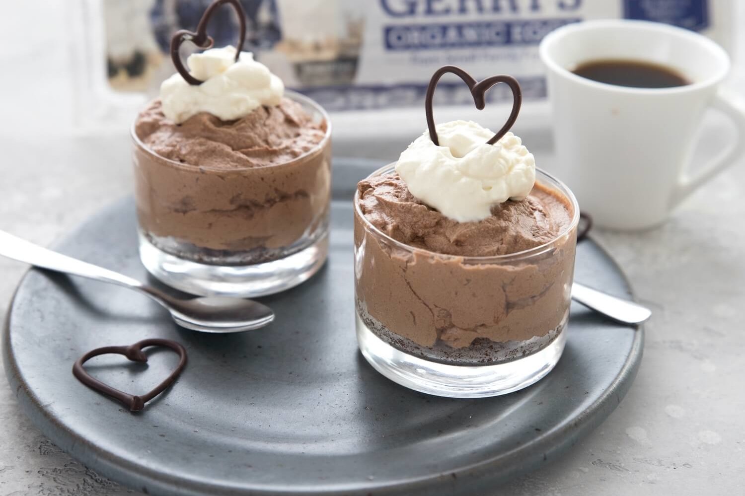 This keto-friendly dessert is perfect for anyone's sweet tooth. Pictured is an almond flour, cocoa powder, and butter crust. On top of the crust is a velvety chocolate filling. Garnished with a chocolate heart drizzle. | peteandgerrys.com 