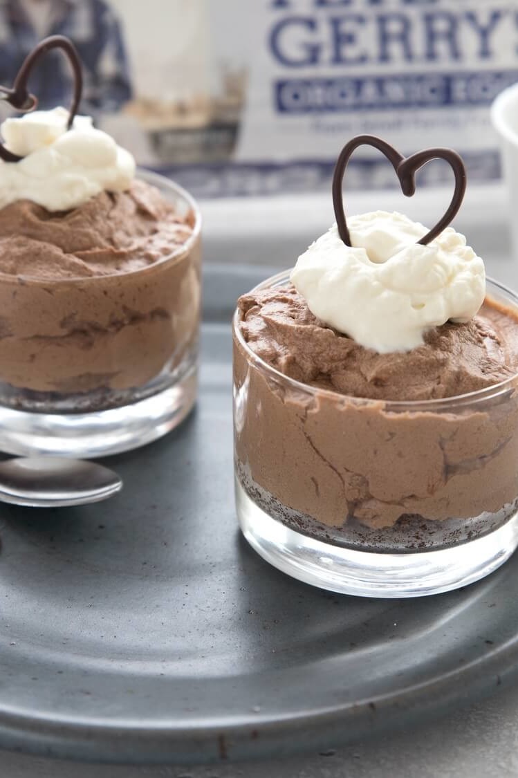 This keto-friendly dessert is perfect for anyone's sweet tooth. Pictured is an almond flour, cocoa powder, and butter crust. On top of the crust is a velvety chocolate filling. Garnished with a chocolate heart drizzle. | peteandgerrys.com 