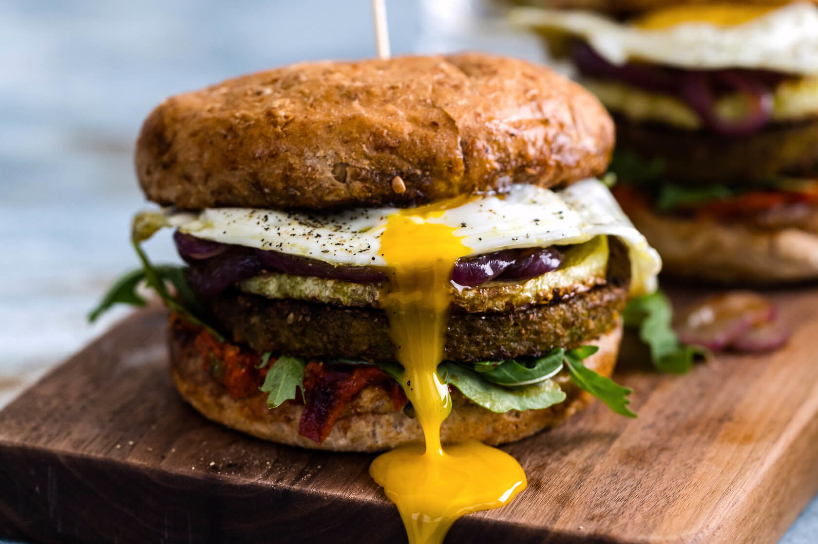 These loaded burgers are kid-friendly and vegetarian. These burgers start with your favorite veggie burgers, topped with a fried egg, and covered in pepper sauce. | peteandgerrys.com 