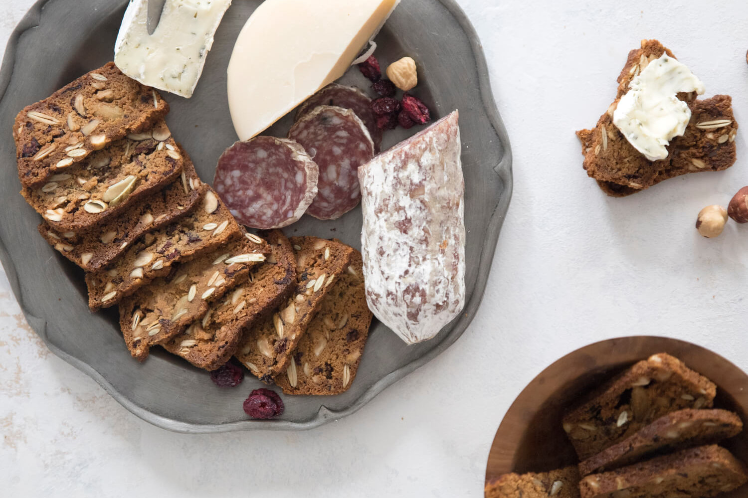 Cranberry hazelnut crisps made with keto-friendly, low carb ingredients and perfect for entertaining or snacking. Pictures on a small charcuterie platter with cheese and salami. | peteandgerrys.com 