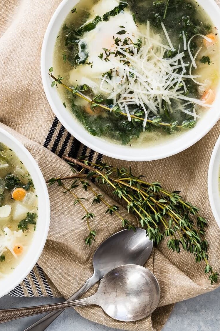 This winter kale and egg soup is perfect during the cold season and is vegetarian friendly. The soup is pictured with steamed kale, poached eggs, and parmesan cheese. | peteandgerrys.com 