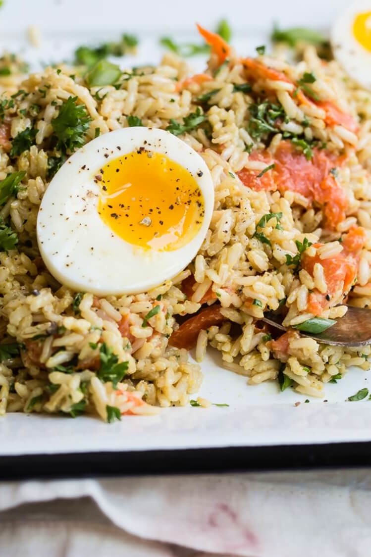 This kedgeree pictures cooked basmati rice, smoked salmon, and soft boiled organic eggs. This dish is garnished with fresh parsley. | peteandgerrys.com 