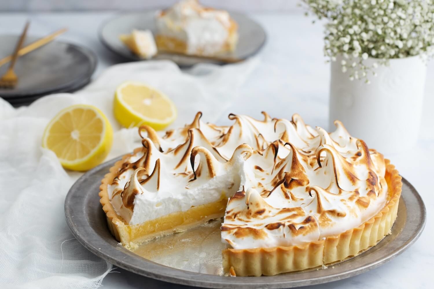 This lemon meringue tart starts with a luscious and flavorful lemon custard. The custard is then topped with an egg white meringue, and torched to perfection. | peteandgerrys.com 