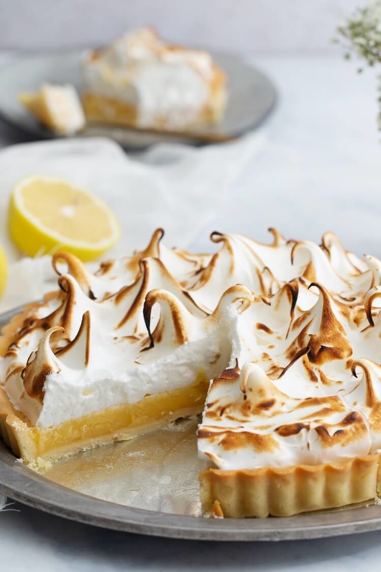 This lemon meringue tart starts with a luscious and flavorful lemon custard. The custard is then topped with an egg white meringue, and torched to perfection. | peteandgerrys.com 