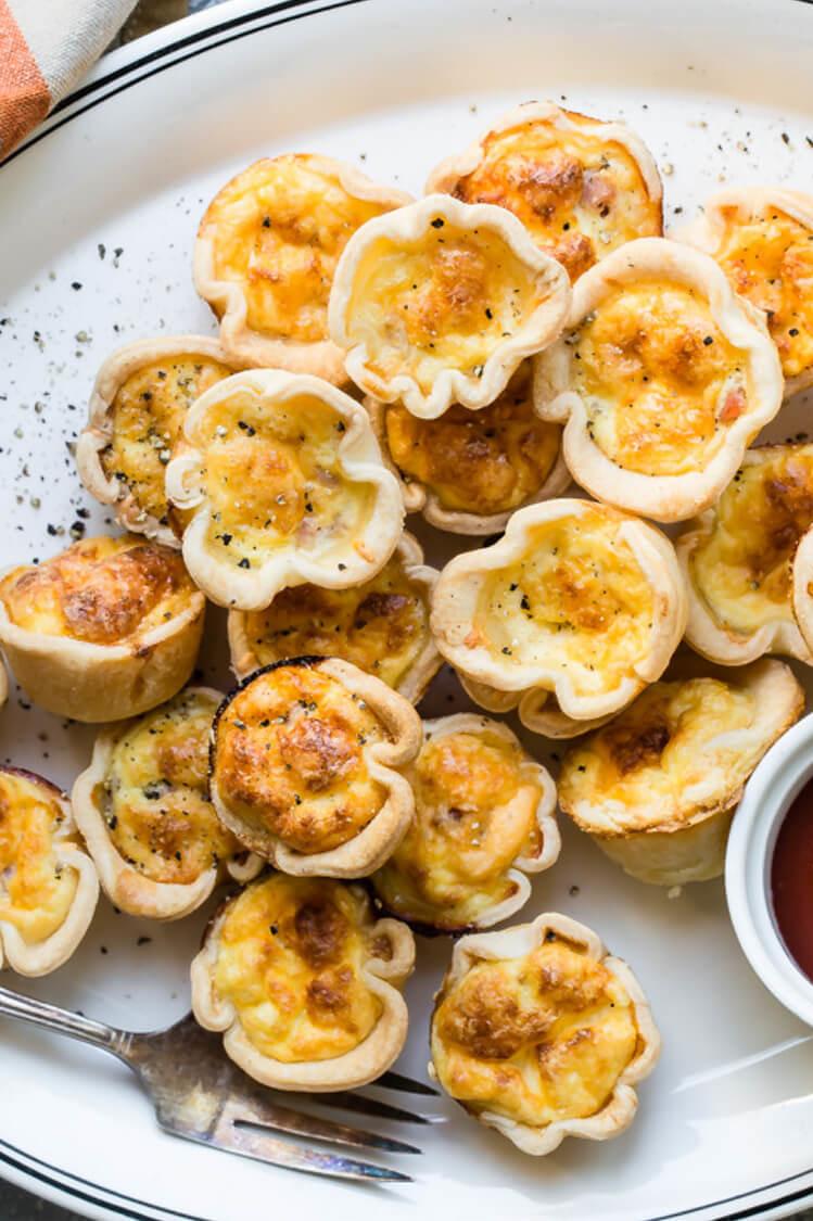 These mini cheese and ham quiches have an organic egg and cream filling with pieces of diced ham. The custard is wrapped in a golden and crispy phyllo wrap. | peteandgerrys.com 