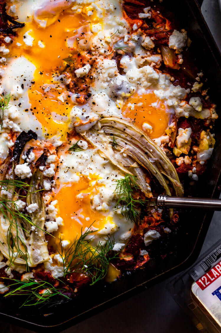 This recipe features fennel, plum tomatoes, feta cheese, and fresh parsley. This dish is topped with baked eggs. | peteandgerrys.com 