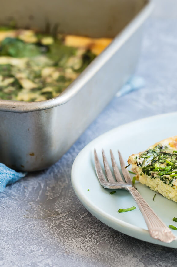 A keto-friendly crustless quiche made in a rectangular casserole pan. Quiche consists of organic eggs, heavy cream, white cheddar cheese, bacon, chives, scallions, and spinach. | peteandgerrys.com 