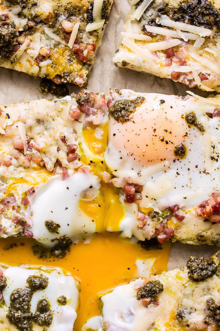 The pancetta egg flatbread features crispy and delicious pancetta, green pesto, and runny fried organic eggs. | peteandgerrys.com 