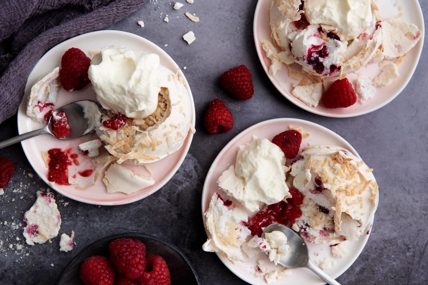 Pavlova snowballs made with a quick and easy meringue, topped with raspberries and sweetened shredded coconut. | peteandgerrys.com 