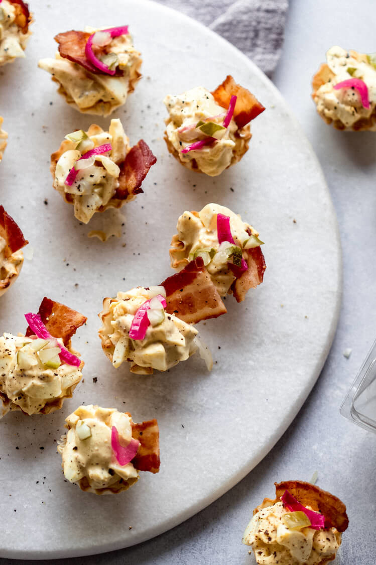 Party-ready phyllo egg salad bites adorned with crispy bacon and homemade pickled red onion. | peteandgerrys.com 