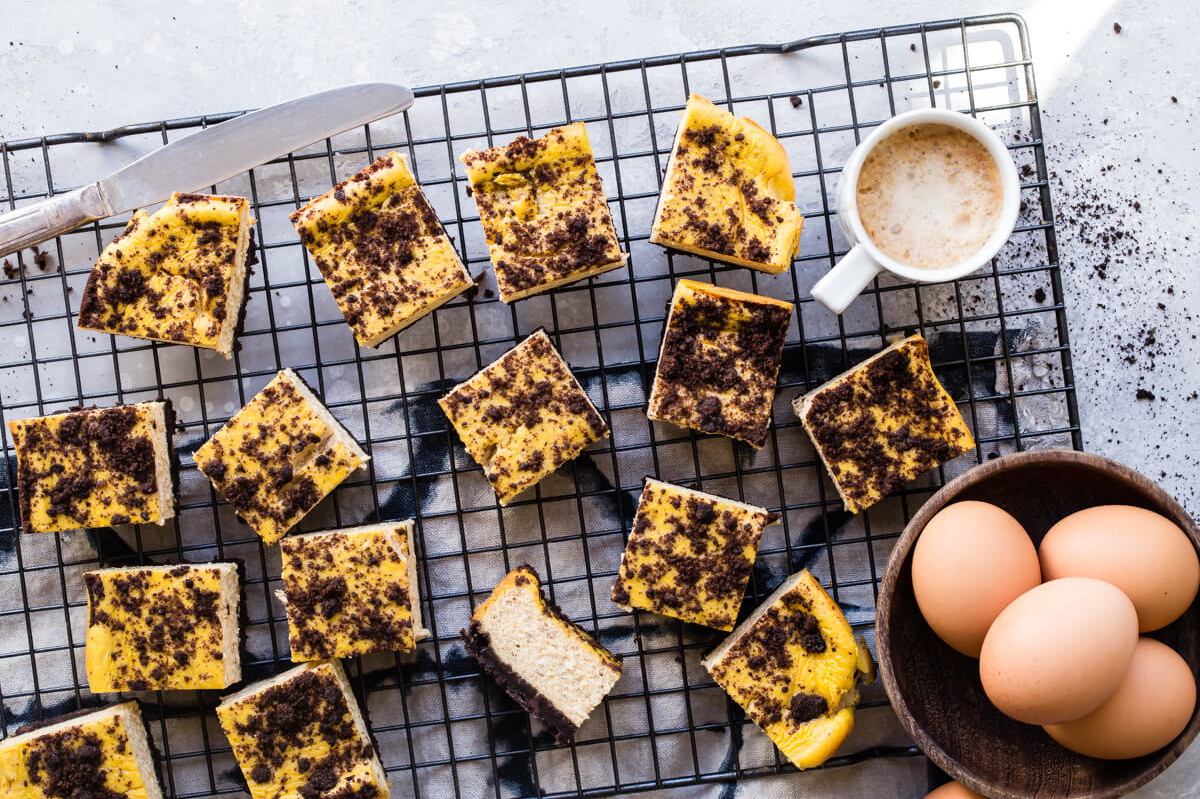 These pumpkin cheesecake bars are a perfect mix of fall spice and chocolate cookie crumbles. This recipe features a chocolate crumb base and filled with a pumpkin purée cream cheese mix. | peteandgerrys.com