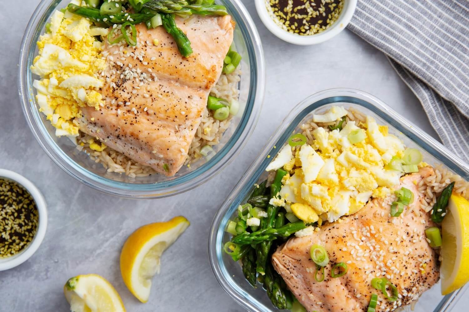 This zesty salmon bowl is based on brown rice, asparagus, scallions, crumbled organic eggs, and seared salmon. | peteandgerrys.com