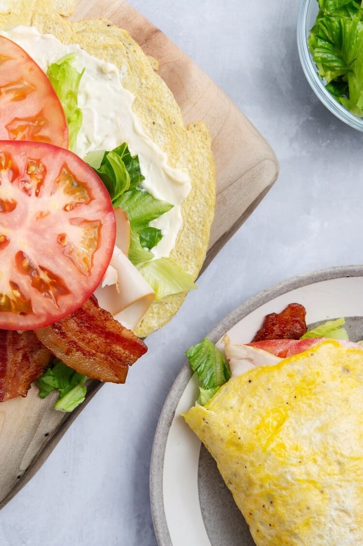 This keto turkey egg wrap is made with organic eggs and spices, and cooked on low until the eggs resemble a wrap. The wrap is filled with deli turkey, bacon, tomato, and lettuce. | peteandgerrys.com 