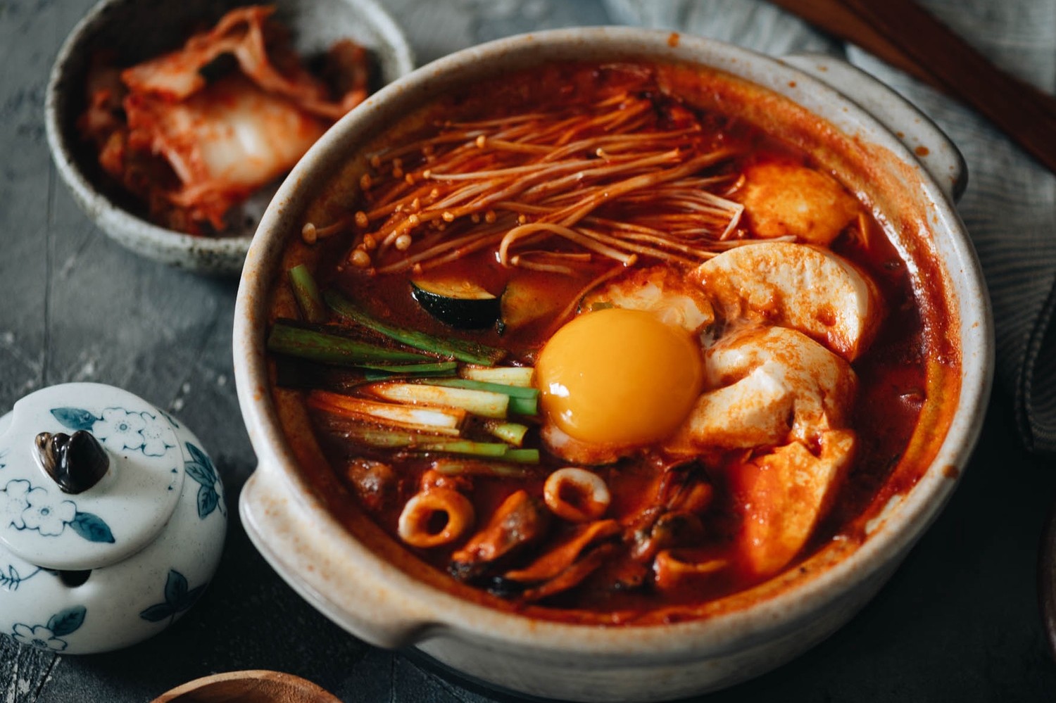 Sundubu jjigae (also known as Korean spicy soft tofu stew) made with a traditional combination of gochugaru, kimchi, pork, seafood, mushrooms, and a Pete and Gerry's Organic Egg yolk.