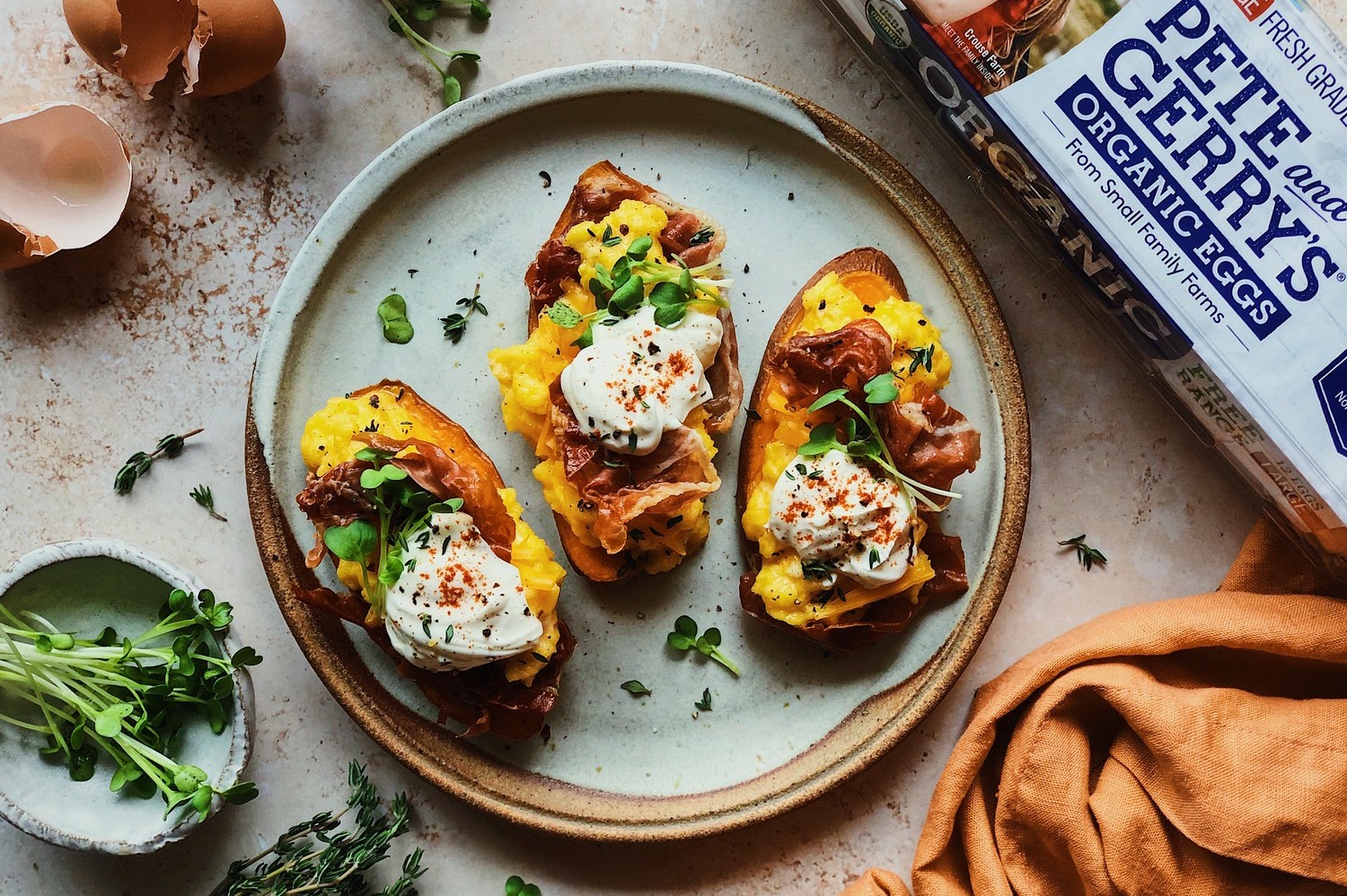 A savory recipe for sweet potato toasts topped with crispy prosciutto, cheesy scrambled eggs, and crème fraîche. | peteandgerrys.com