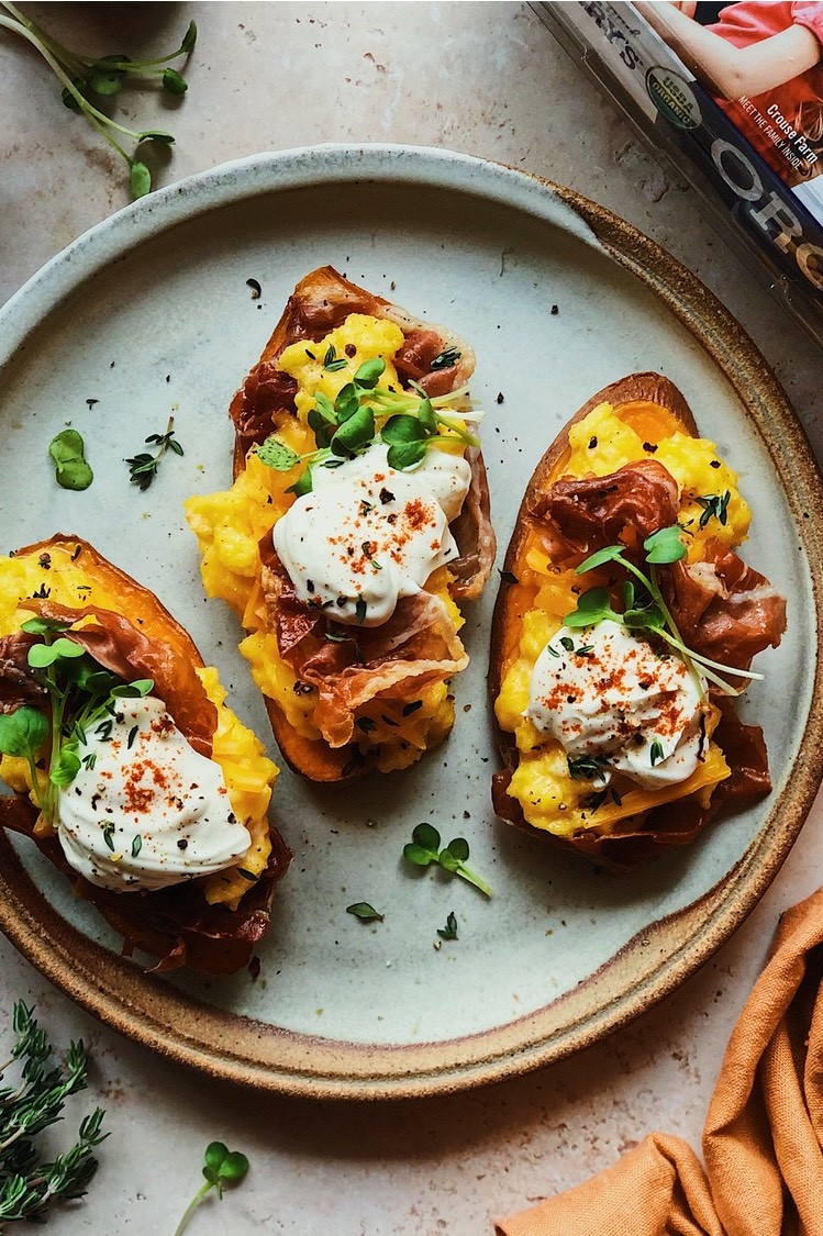 A savory recipe for sweet potato toasts topped with crispy prosciutto, cheesy scrambled eggs, and crème fraîche. | peteandgerrys.com